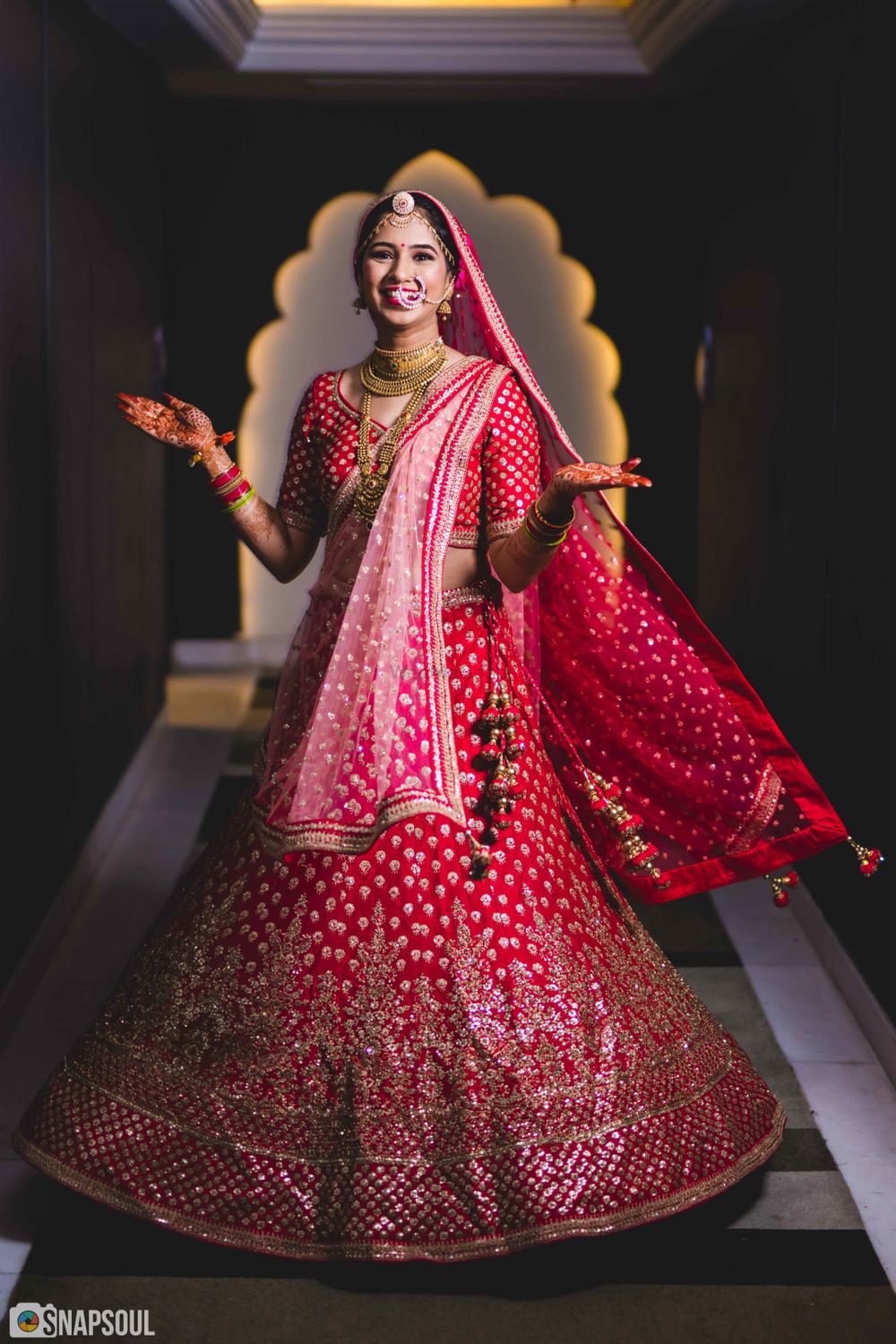 Photo of Red and pink bridal lehenga happy bride