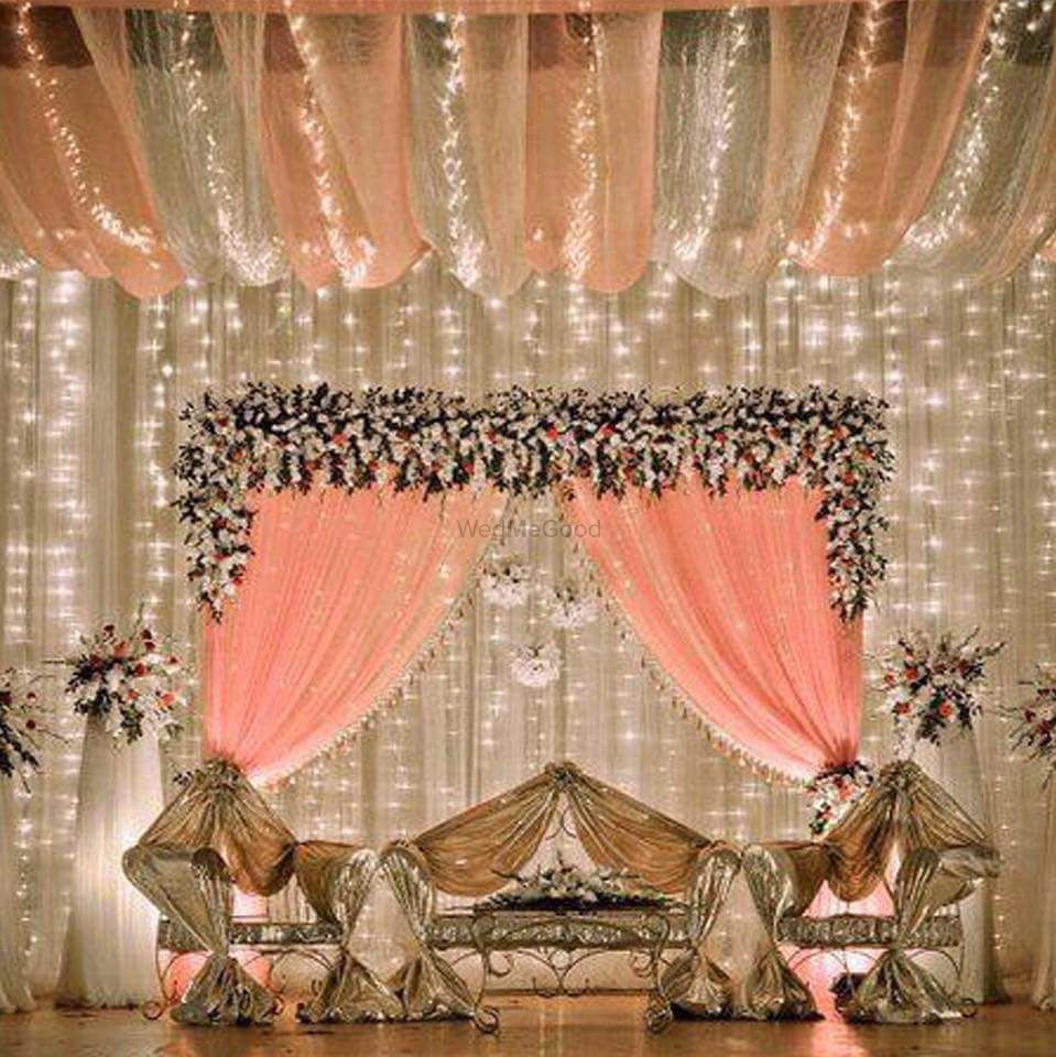 Photo of Stage decor  with fairy lights and peach