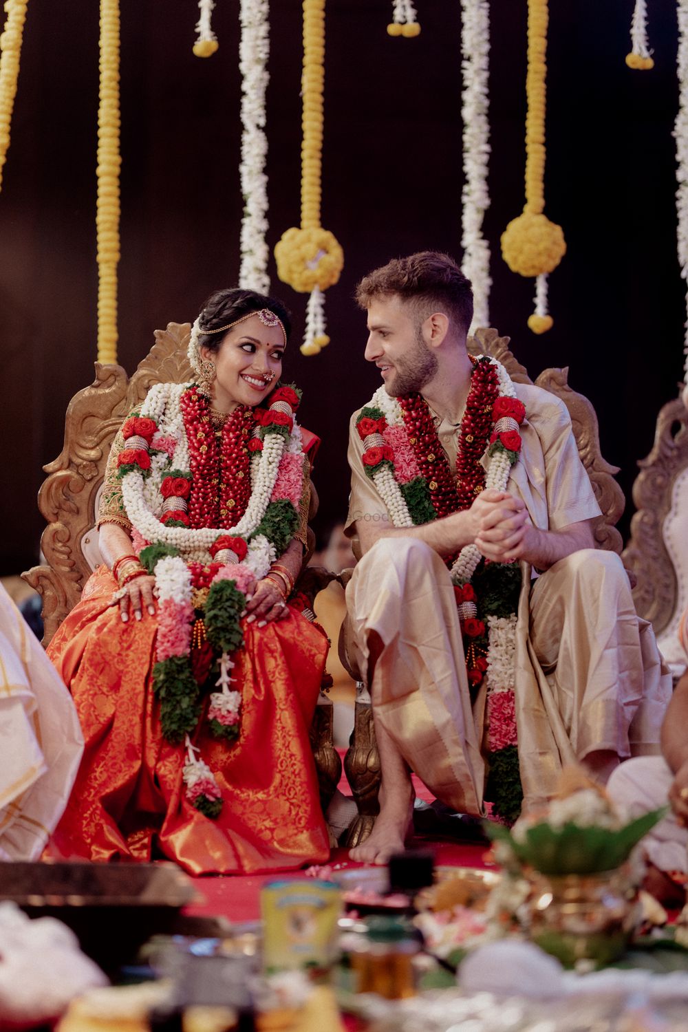 Photo of Couple looking at each other and happily posing after the jaimala ceremony