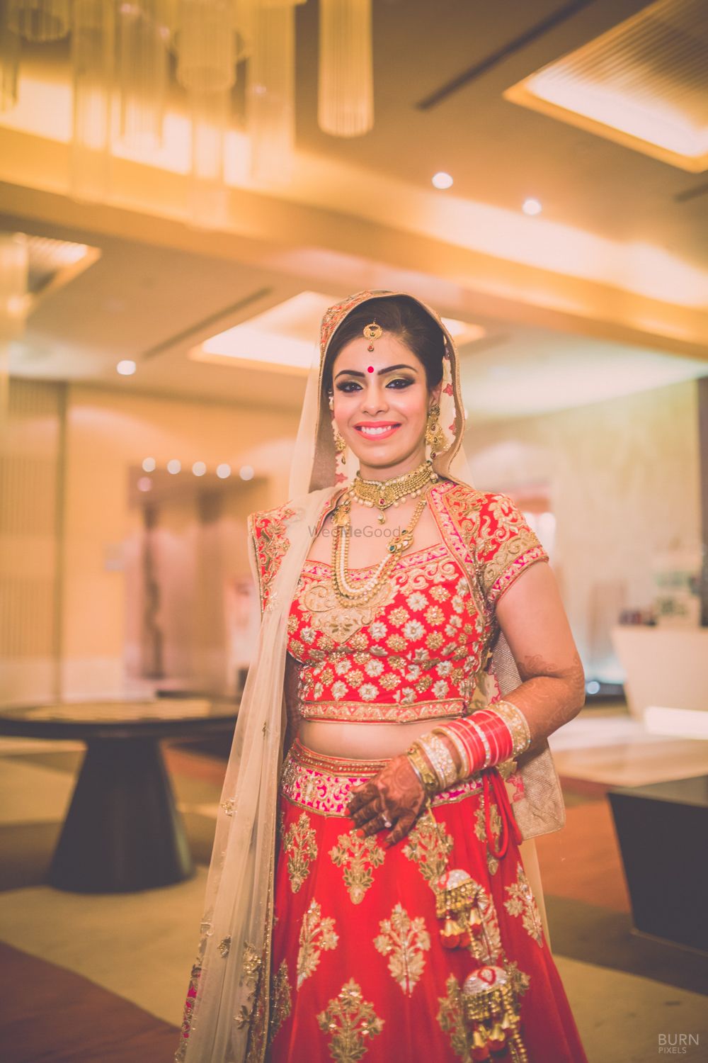 Photo of Smiling Bride in Red and Gold Lehenga