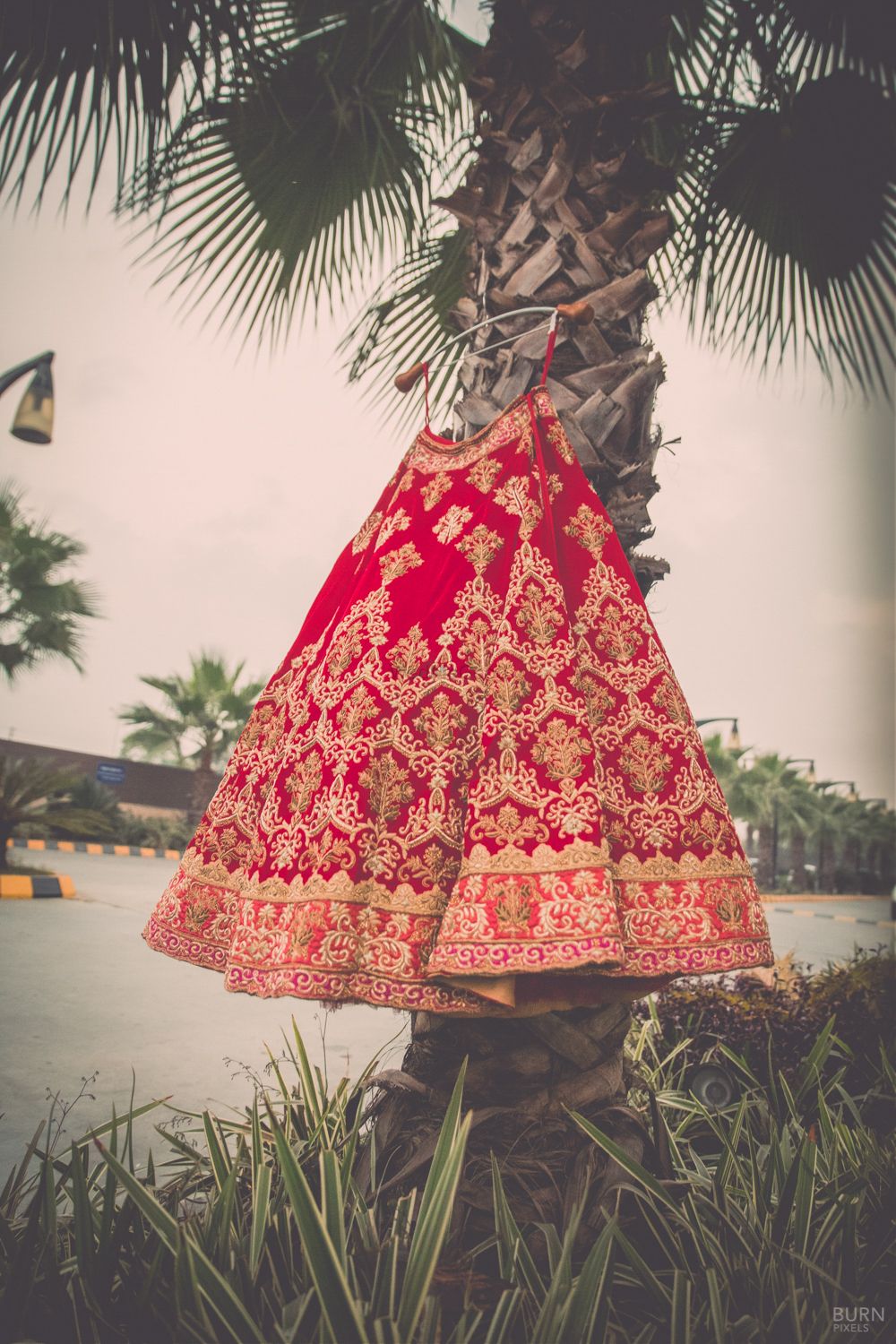 Photo of Red and Gold Bridal Lehenga on a Hanger