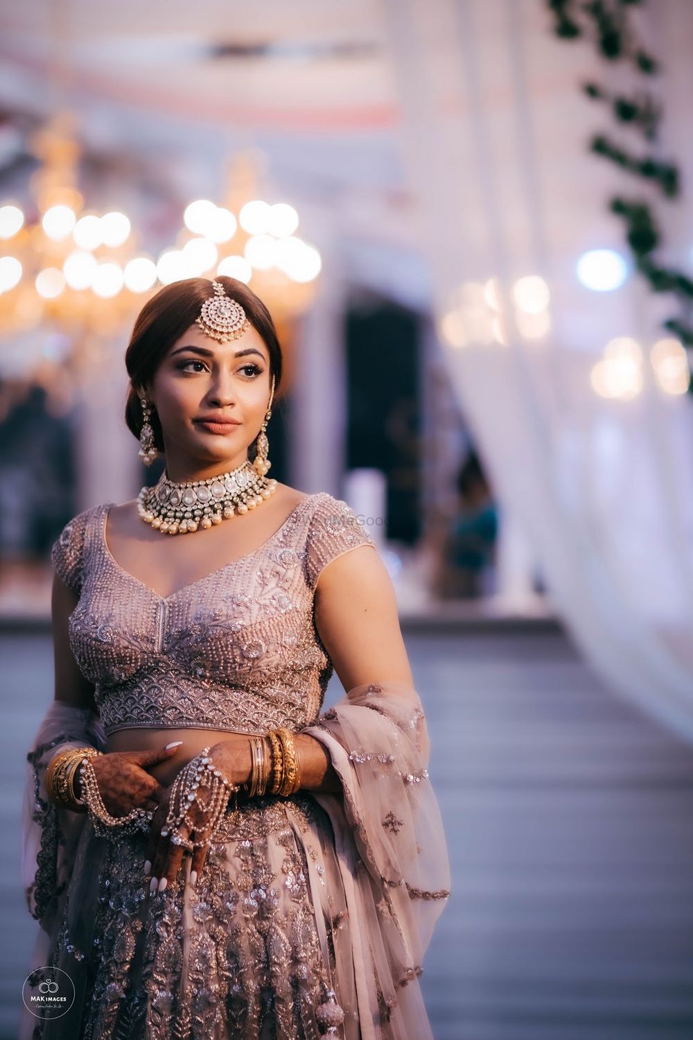 Photo of Bride dressed in an ivory and silver lehenga.