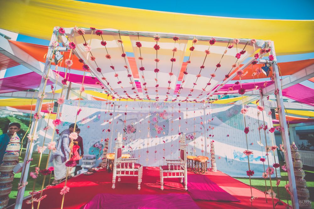 Photo of Yellow Pink and Blue Tents with Floral Mandap Decor