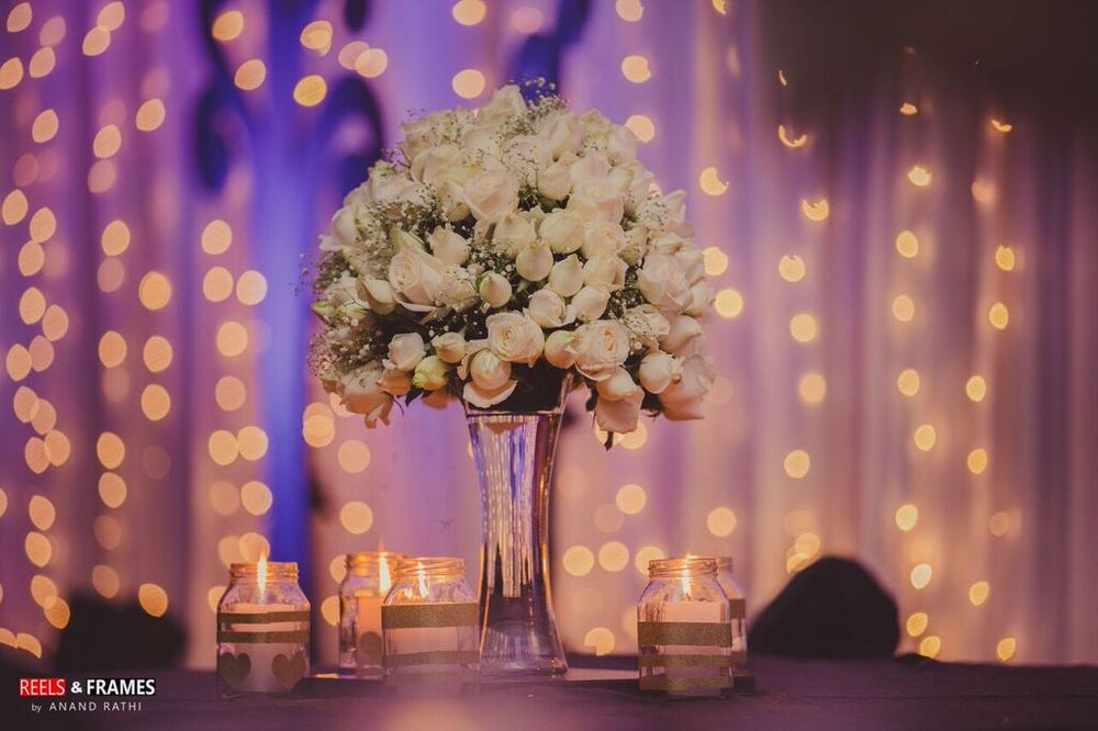 Photo of Floral Centerpiece with Mason Jars and Fairy Lights
