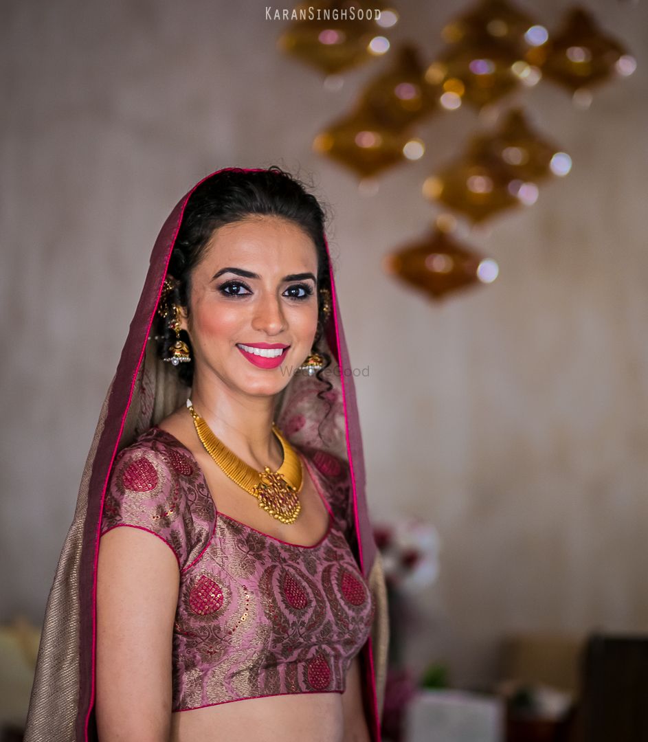 Photo of Bride wearing Gold Jewelry and Pink Lehenga