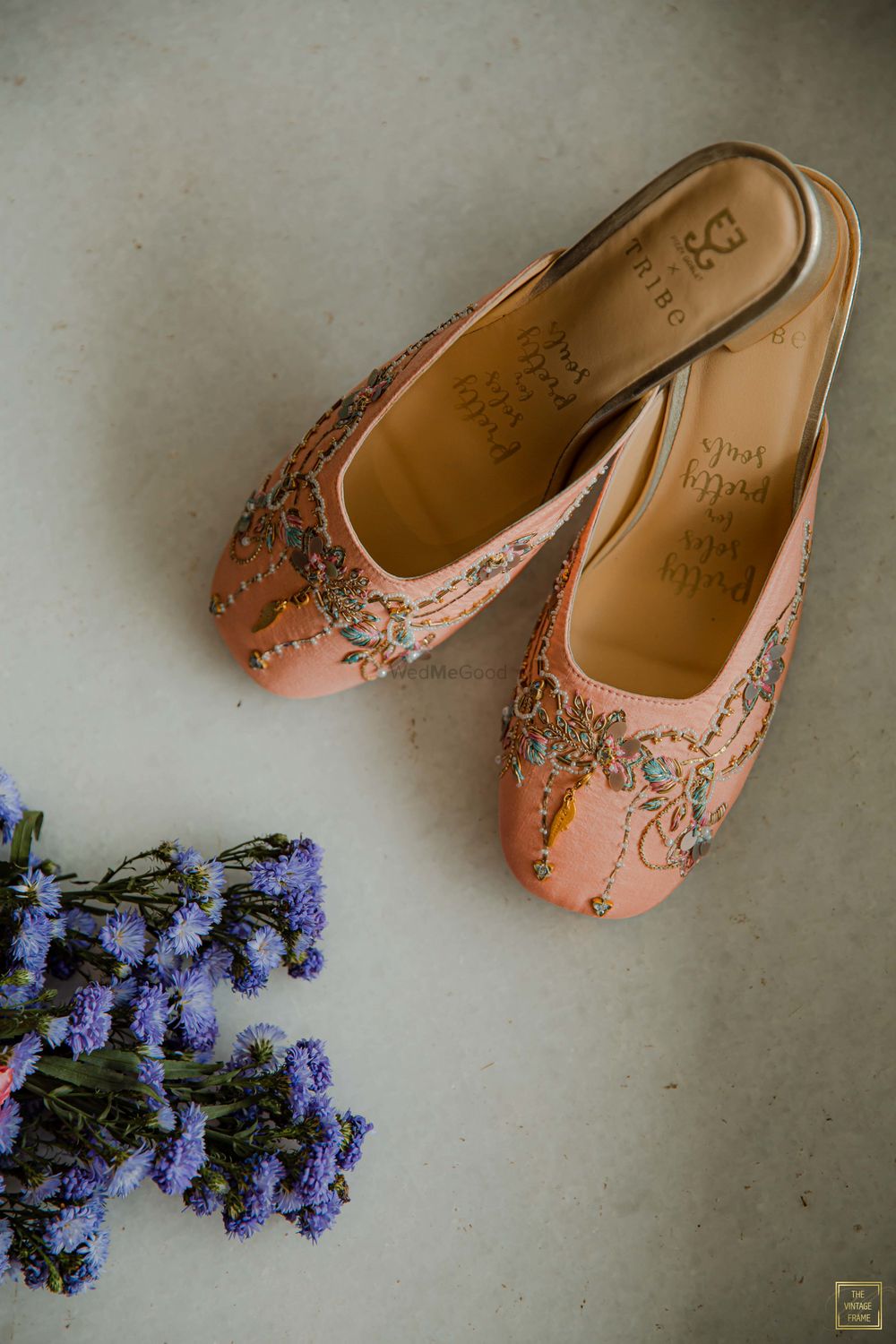 Photo of Peach juttis with floral embellishments for the bride