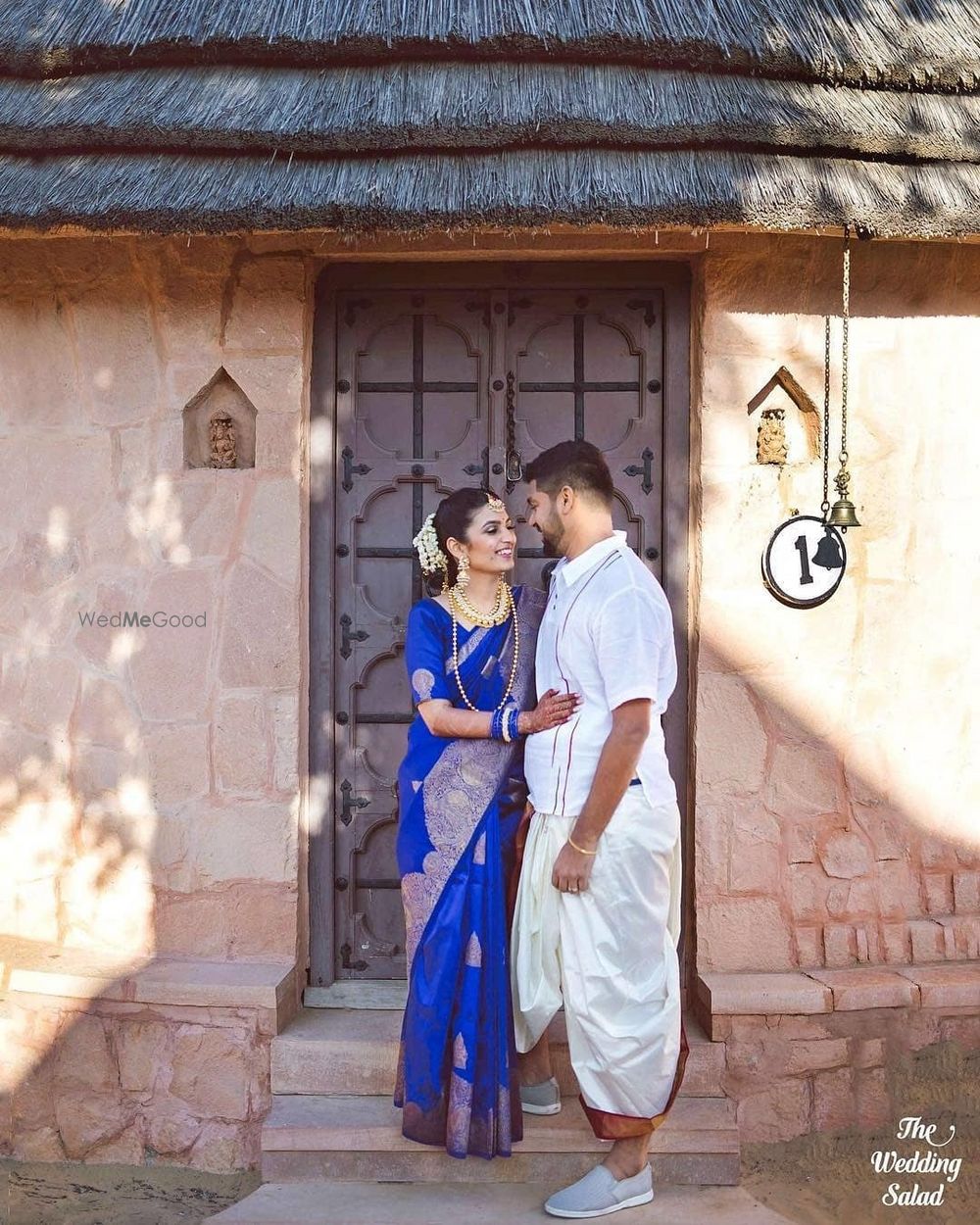 Photo of A cute candid moment captured between the bride and groom