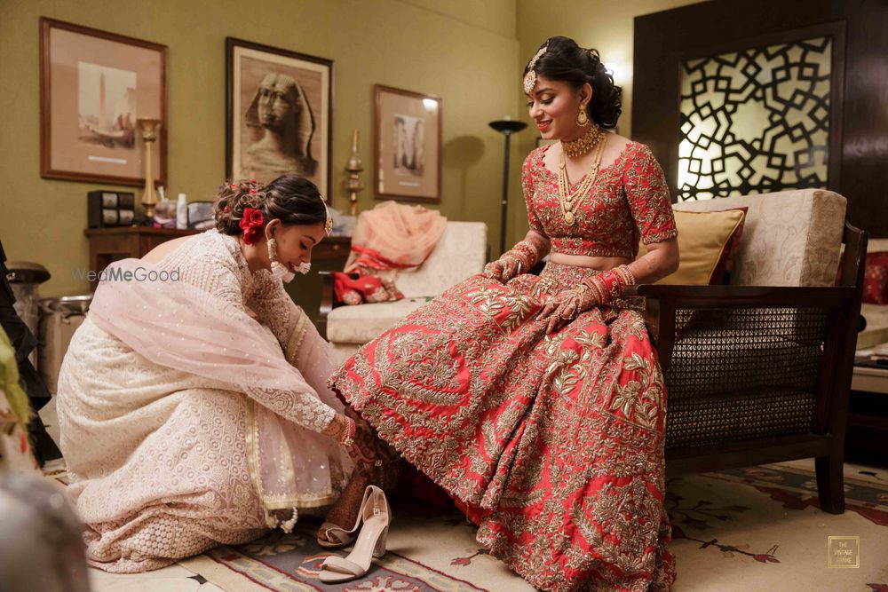 Photo of A bride getting ready with the help of her sister