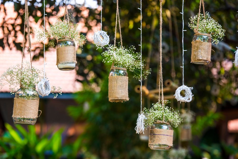 Photo of Hanging Mason Jars with Flowers and Burlap Sacs Decor
