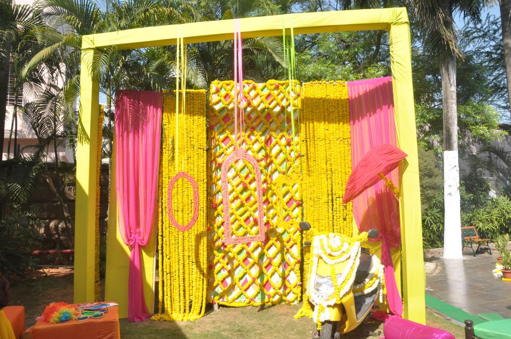 Photo of yellow and pink photo booth with frames