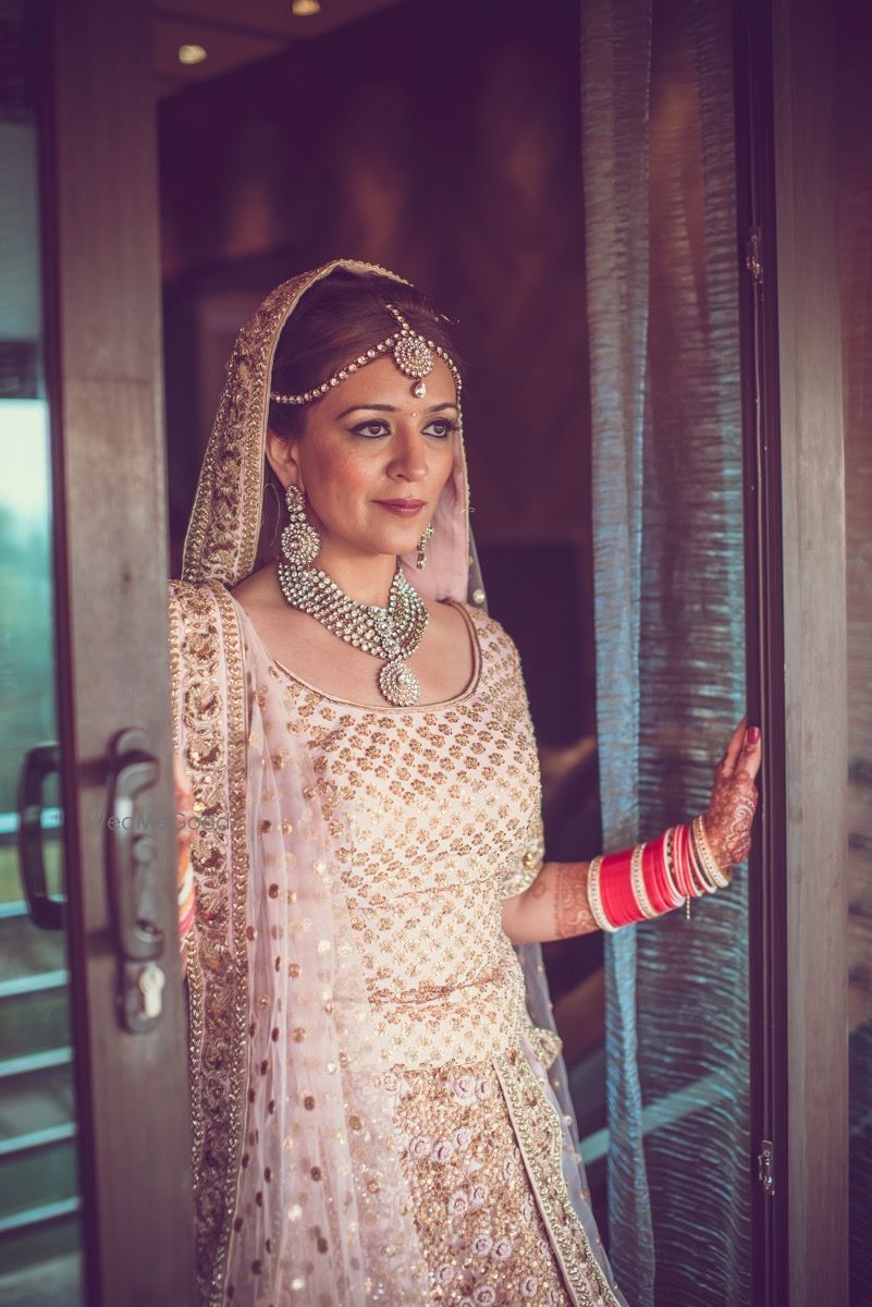 Photo of Bride wearing Cream and Gold Lehenga