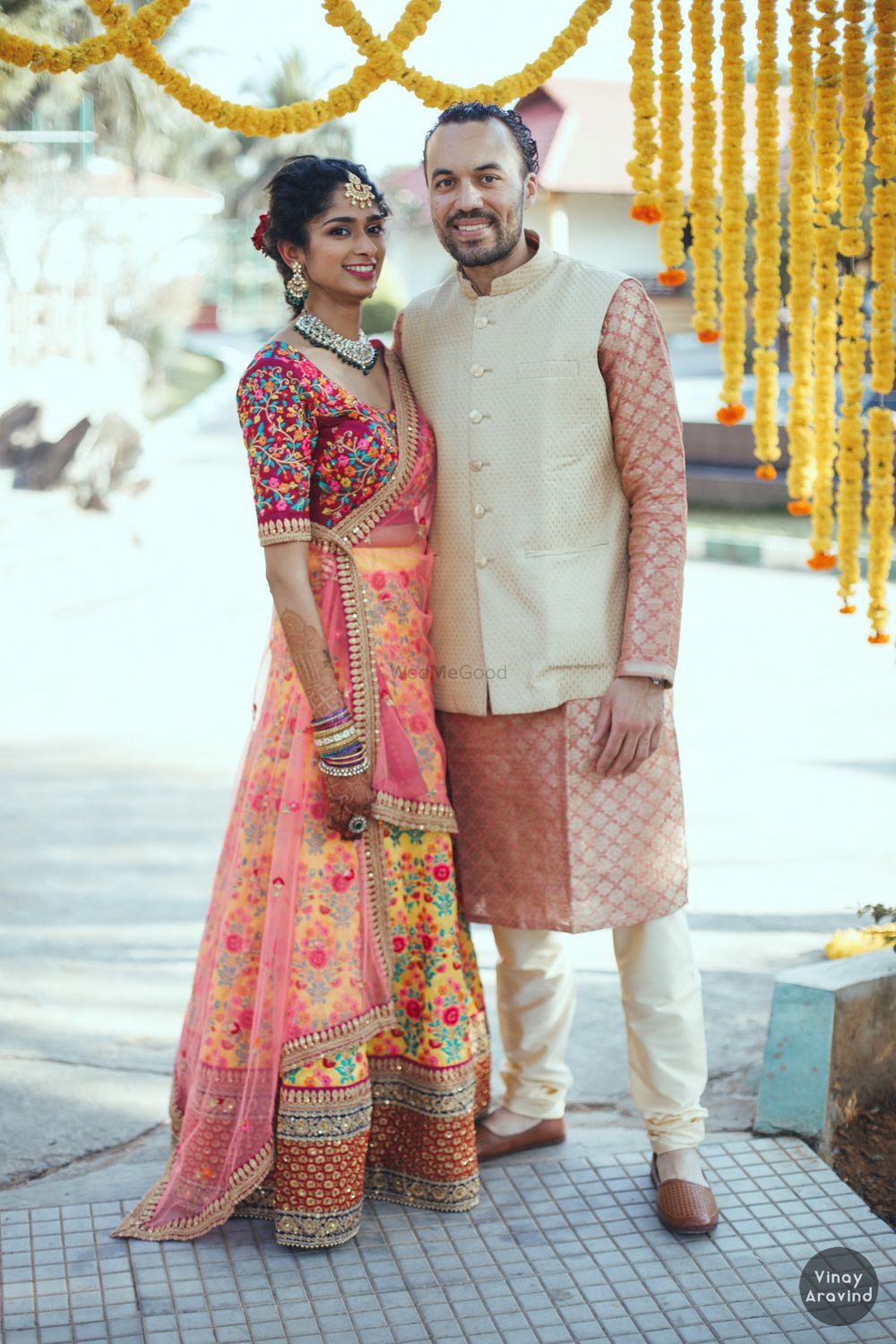 Photo of Bride in a stunning multi-colored lehenga