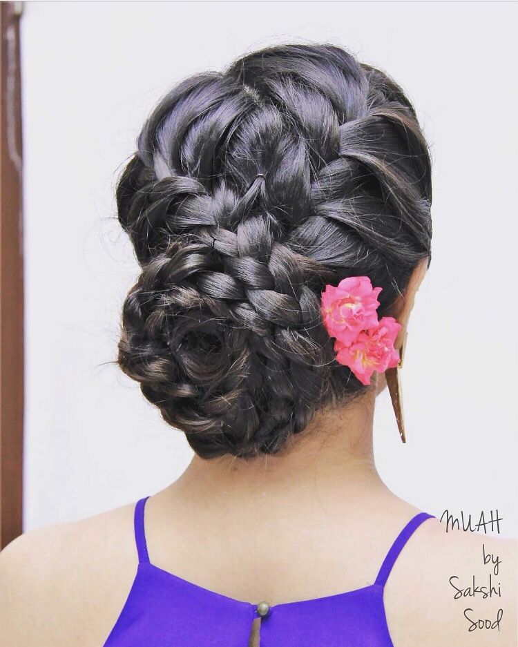Photo of Braided bun hairstyle with pink flowers