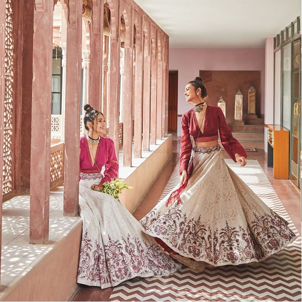 Photo of Bride's friends twirling in this beautiful lehenga .