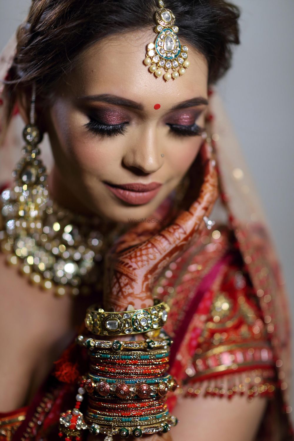 Photo of bridal makeup with red pink eyes