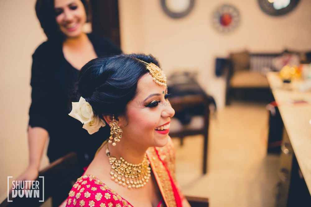Photo of Bride in Gold Maangtikka with White Flowers in Hair
