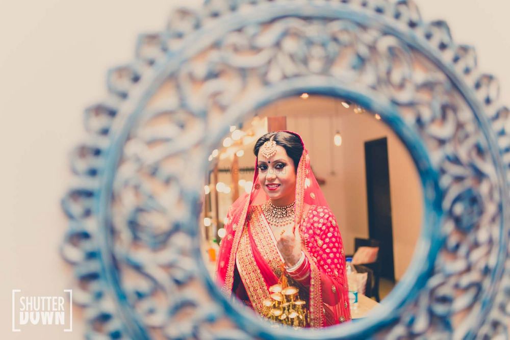Photo of Hot Pink Bride Shot Through the Mirror