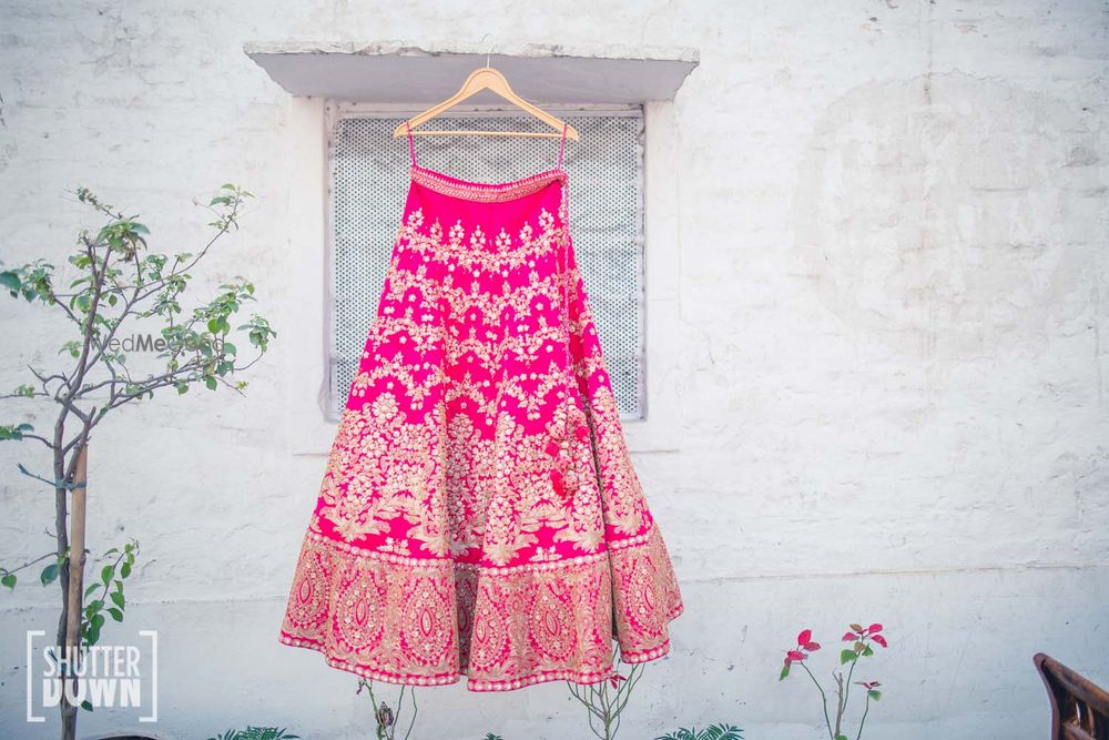 Photo of Hot Pink Bridal Lehenga on a Hanger