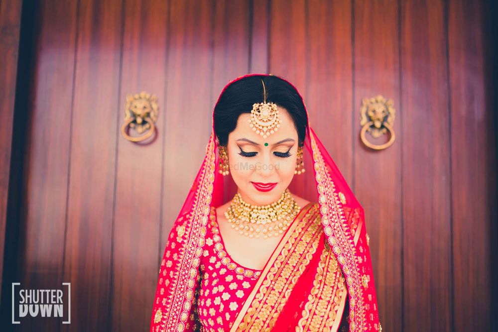 Photo of Candid Bride in Pink and Gold Lehenga