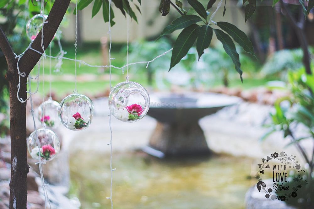 Photo of White Hanging Glass Balls with Flowers