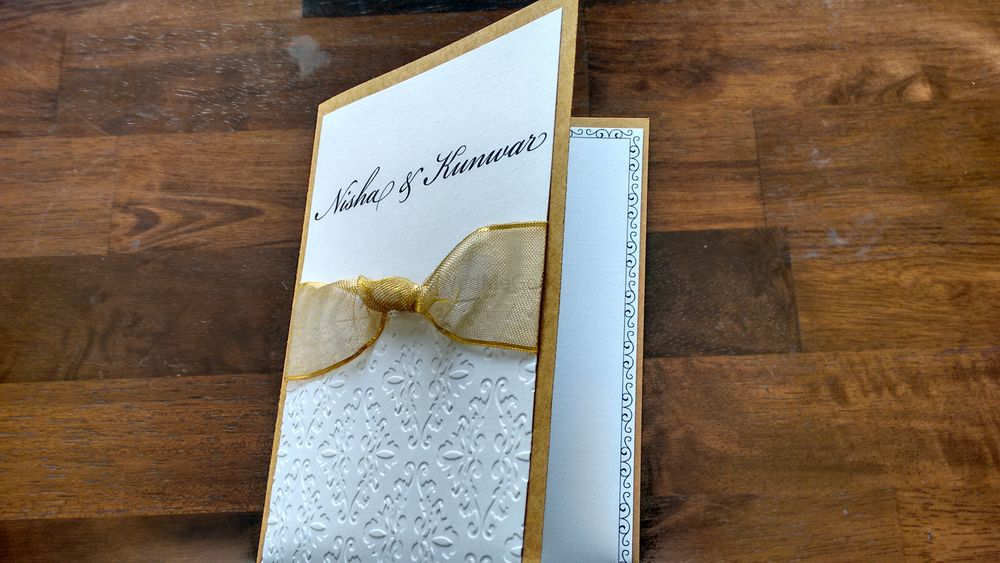 Photo of white and gold invitations 3d cards with gold ribbon