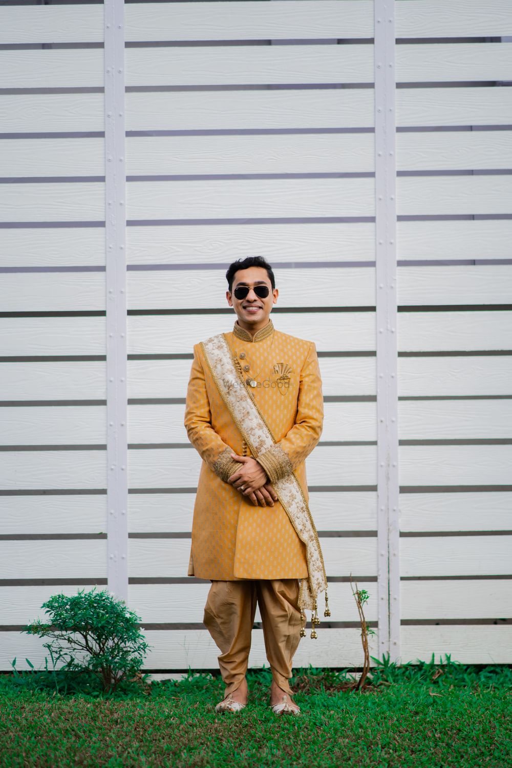 Photo of Groom dressed in a yellow bandhgala with a jodhpuri style pants.