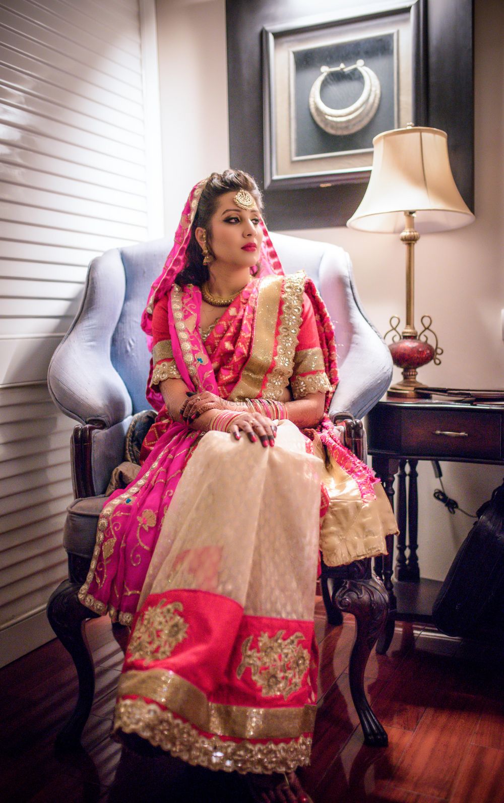 Photo of Bride wearing bright pink and white lehenga