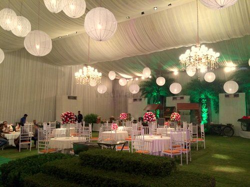 Photo of white draped ceiling with hanging lanterns