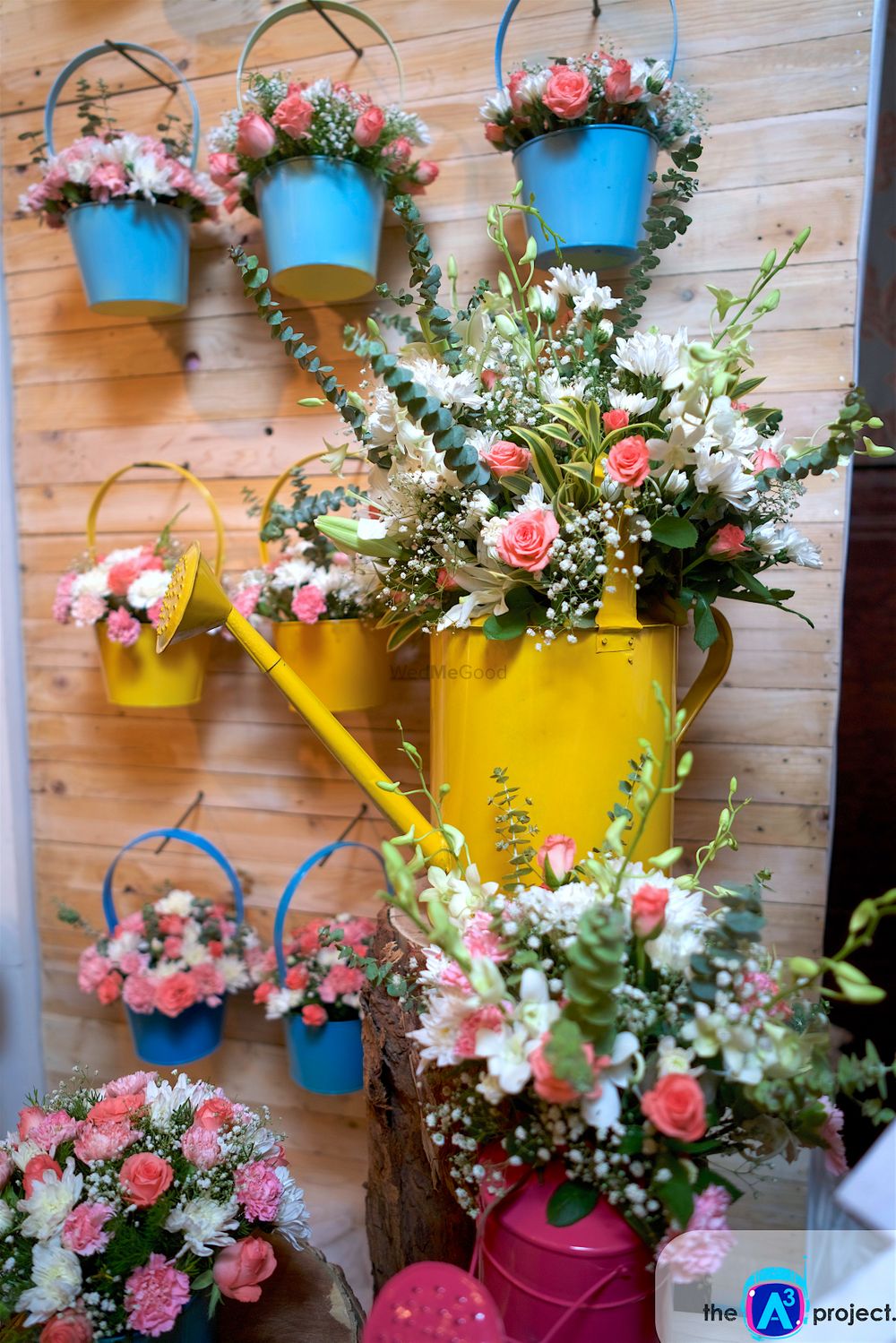 Photo of Cute Floral Arrangement with Watering Cans and Buckets