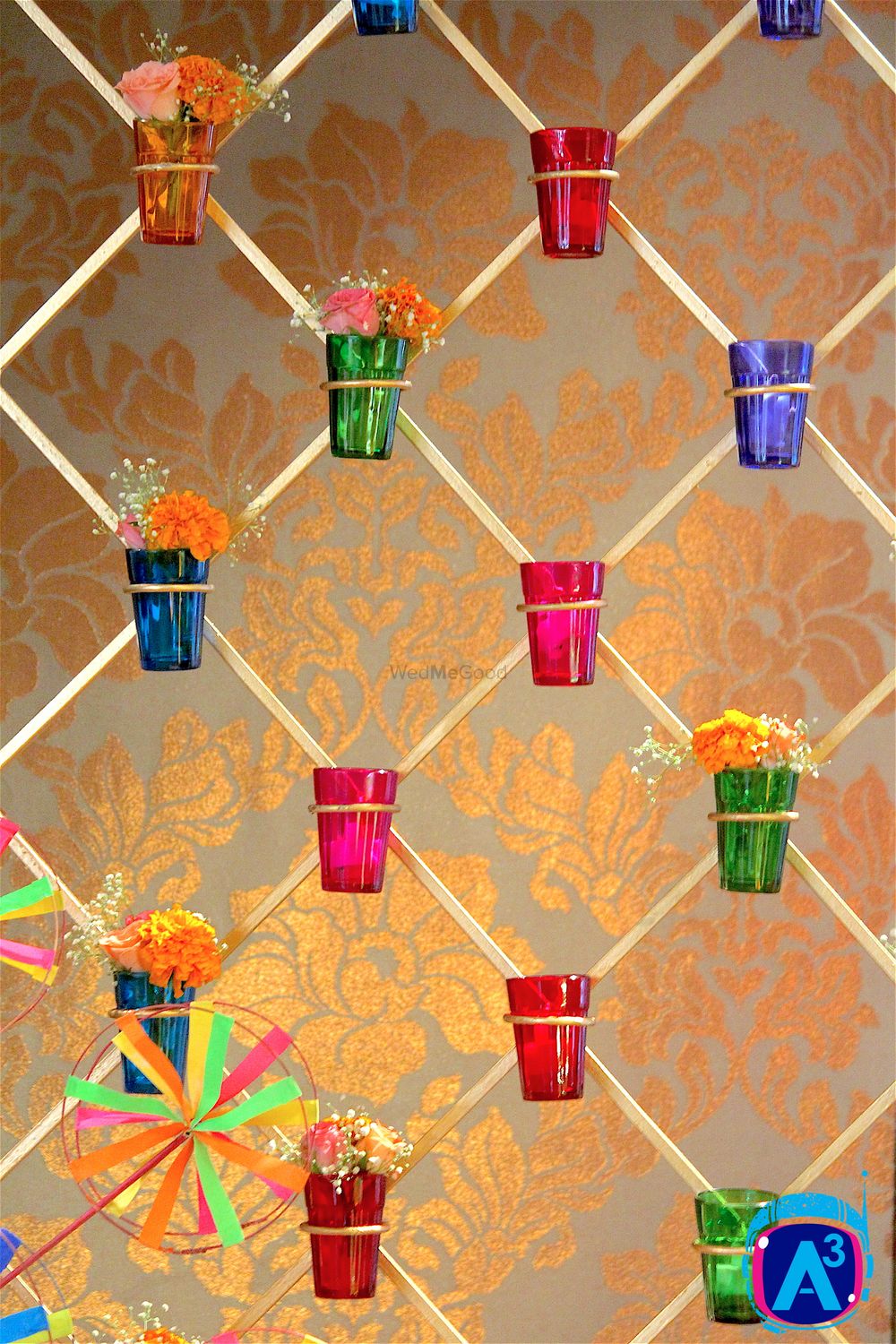 Photo of Floral Arrangement in Suspended Multicolour Tumblers