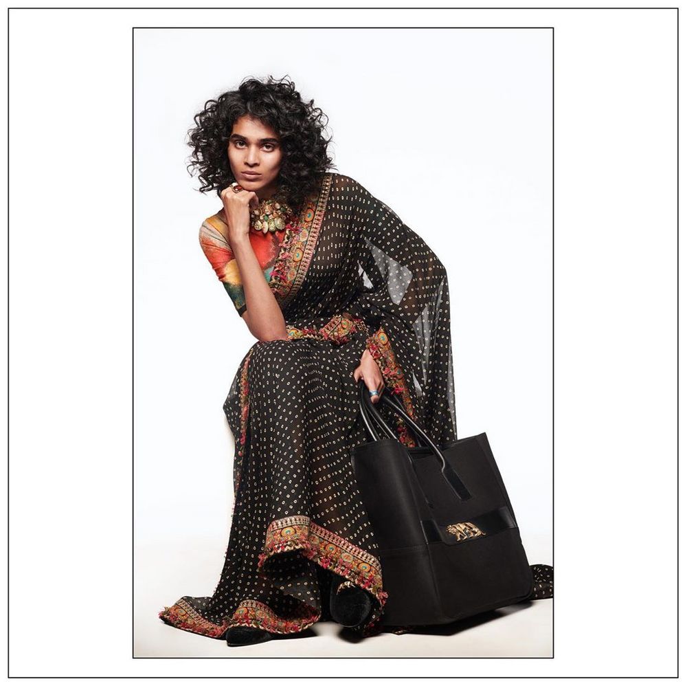 Photo of  Modern Folklore Saree with a Beautiful Designer Bag.