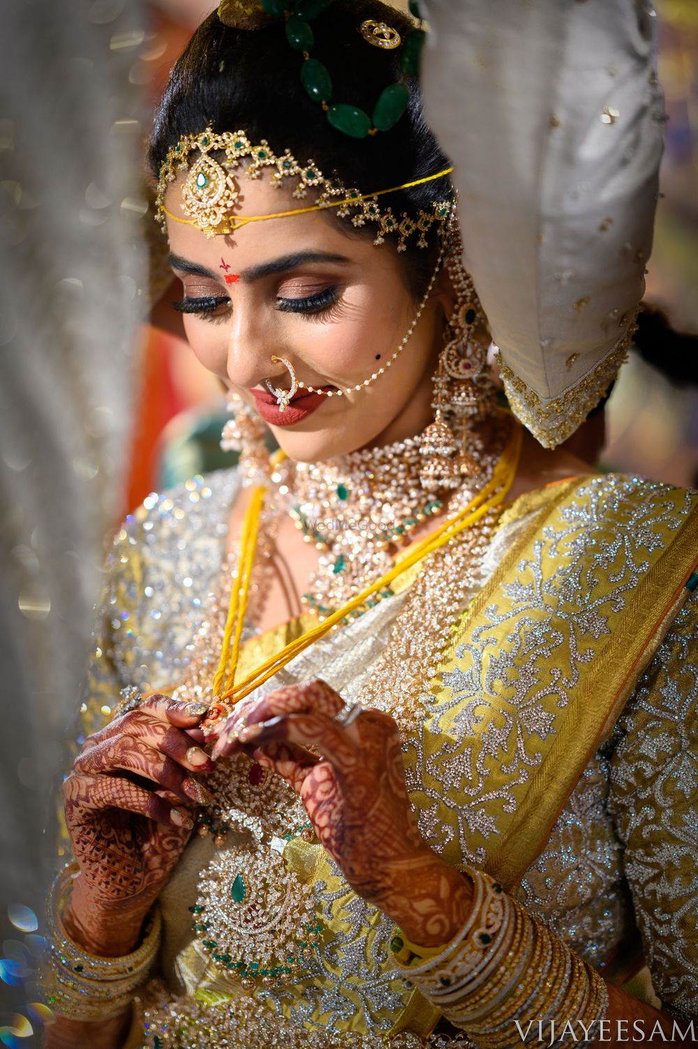 Photo of Candid shot of a South Indian bride in between the rituals.