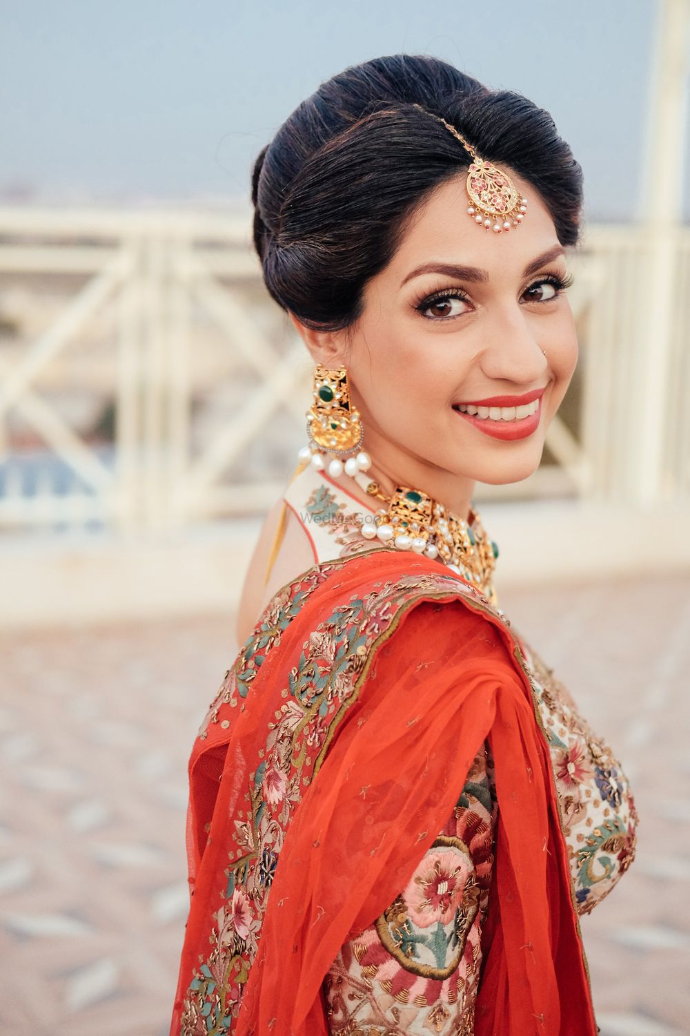 Photo of Bridal Makeup and Updo with Rust Lehenga