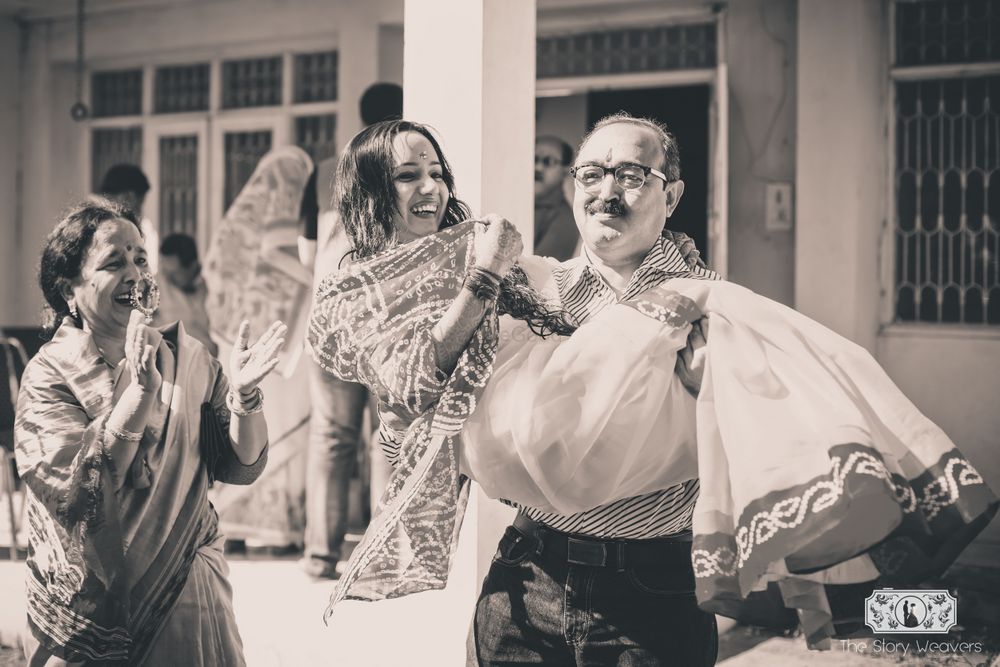 Photo of Fun Photo with Father Picking Bride in his Arms