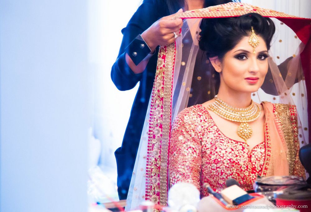 Photo of Dupatta Being Placed on Bride in Red