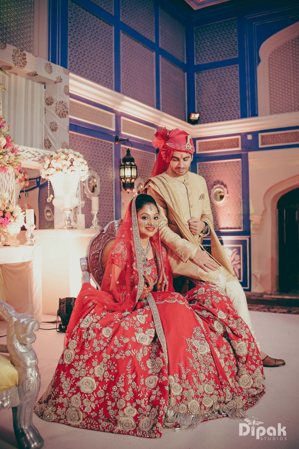 Photo of Bride Posing in Bright Red Flared Lehenga on Stage