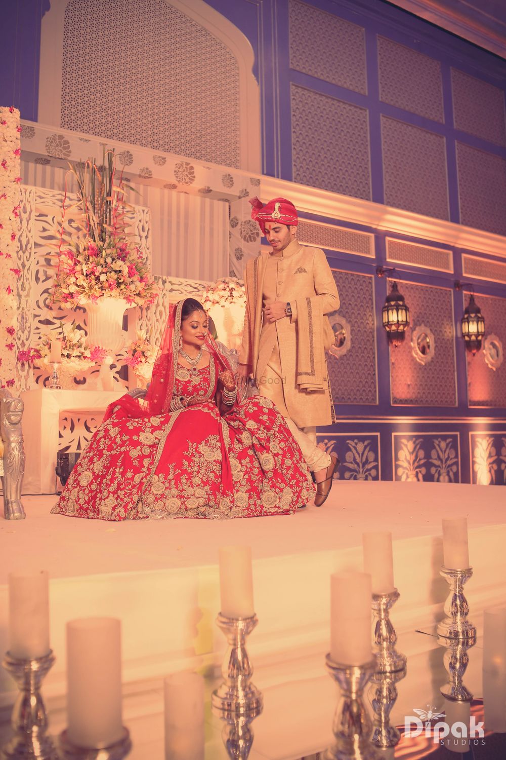 Photo of Bride Wearing Bright Red Flared Lehenga on Stage