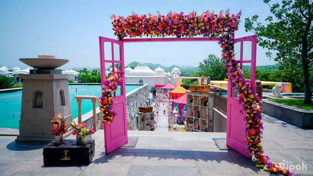 Photo of Pink Door with Florals and Vintage Suitcase