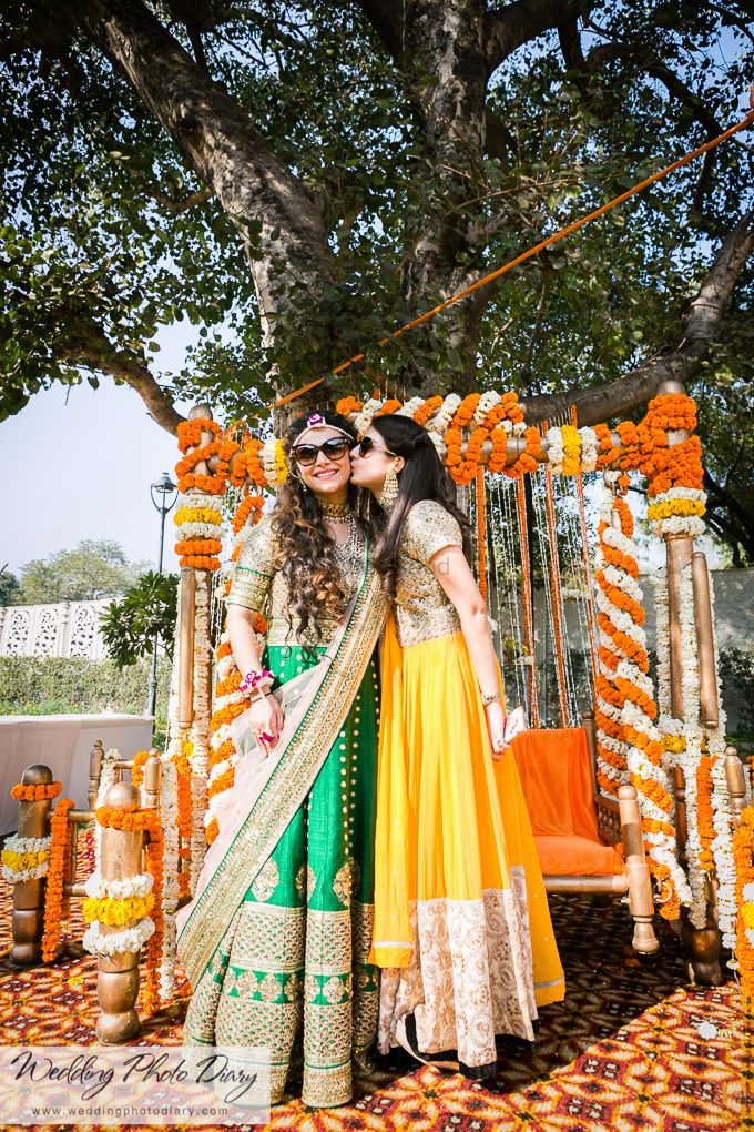 Photo of Bride and Sister Fun Photo at Outdoor Mehendi