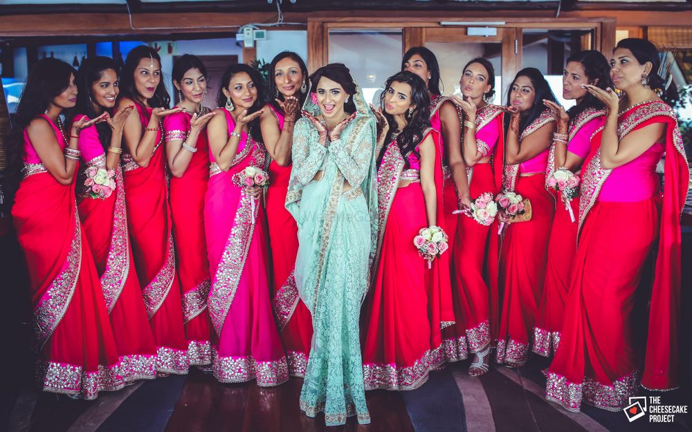 Photo of Bride with Matching Bridesmaids Wearing Pink Saris