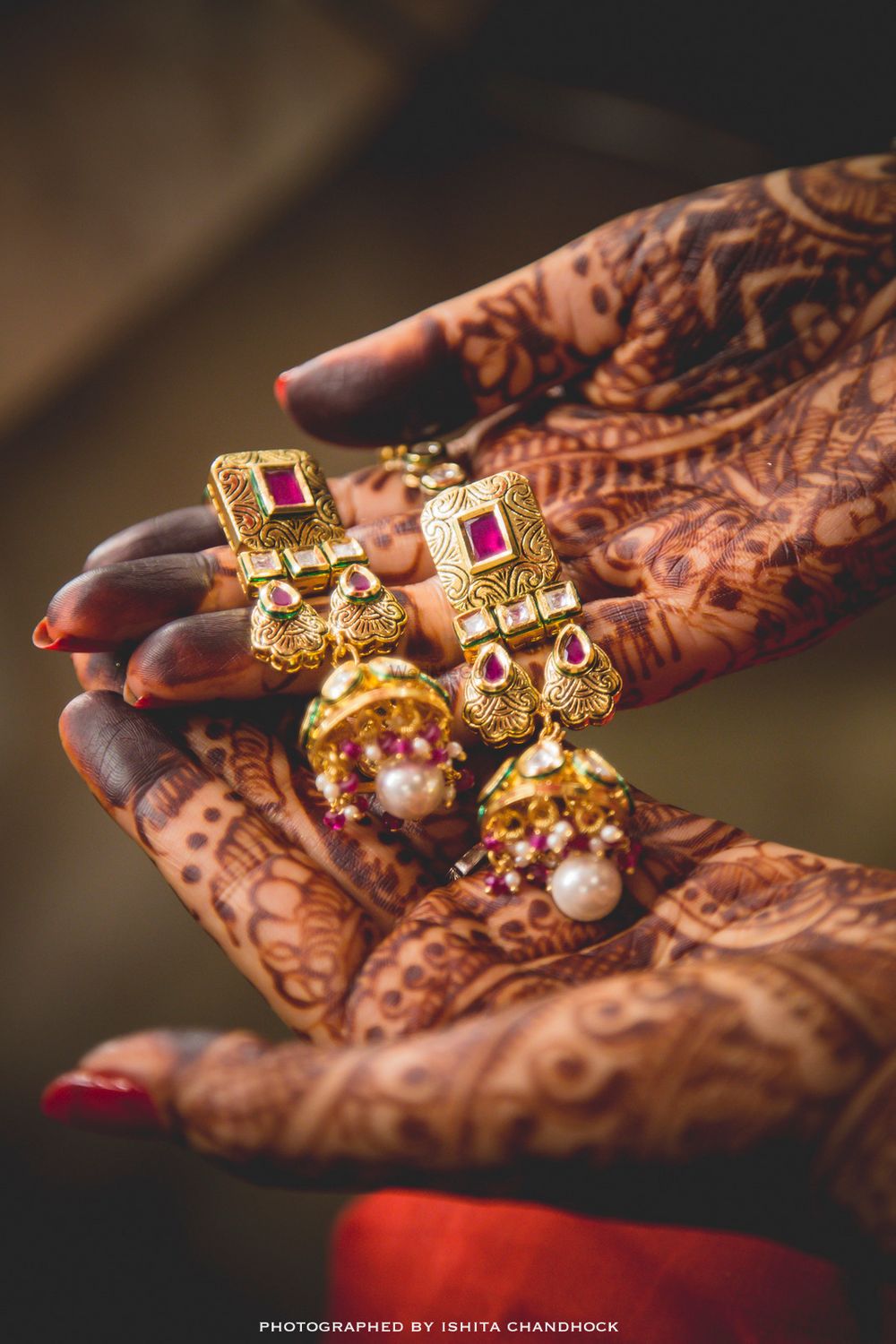 Photo of Bride Holding Pink and Gold Polki Danglers