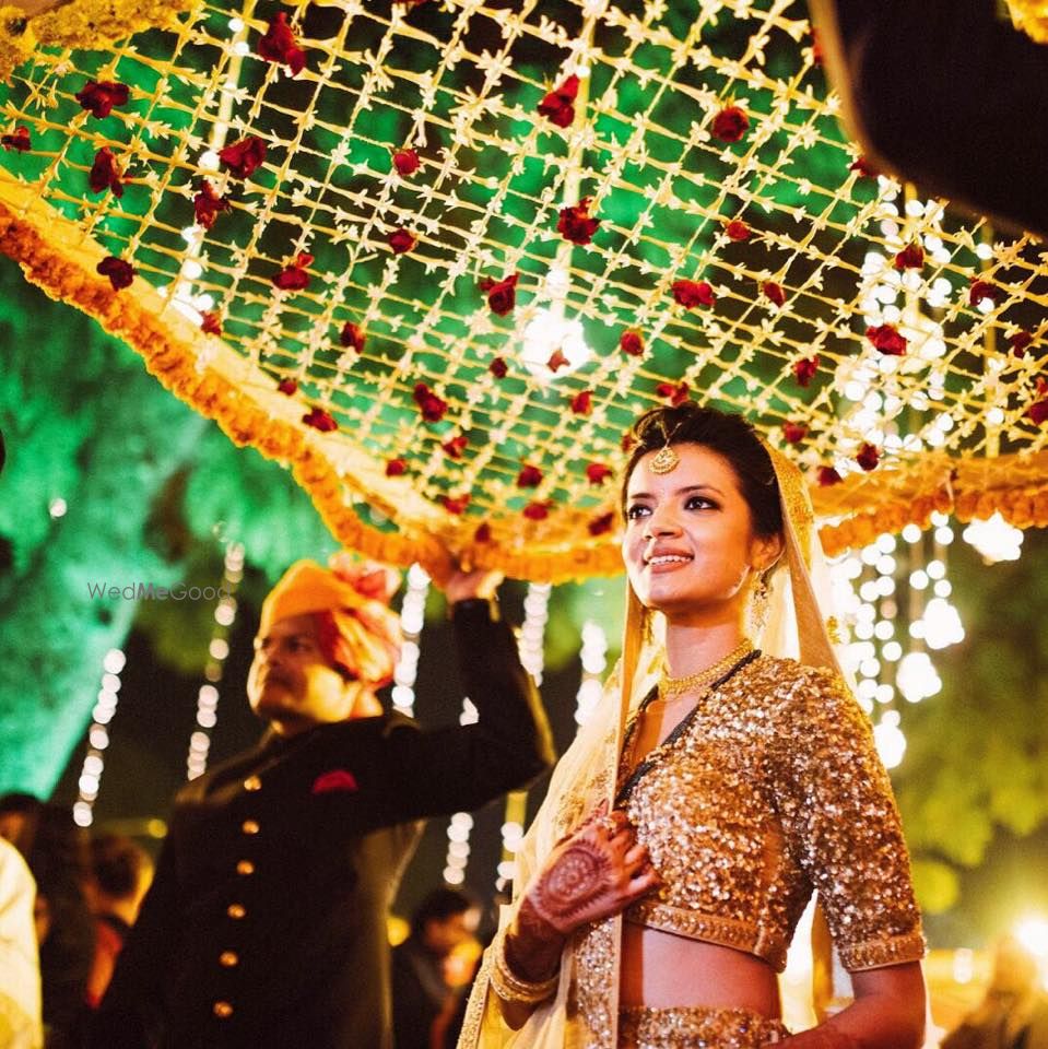 Photo of Bride in Gold Lehenga Entering Under Phoolon ki Chadar