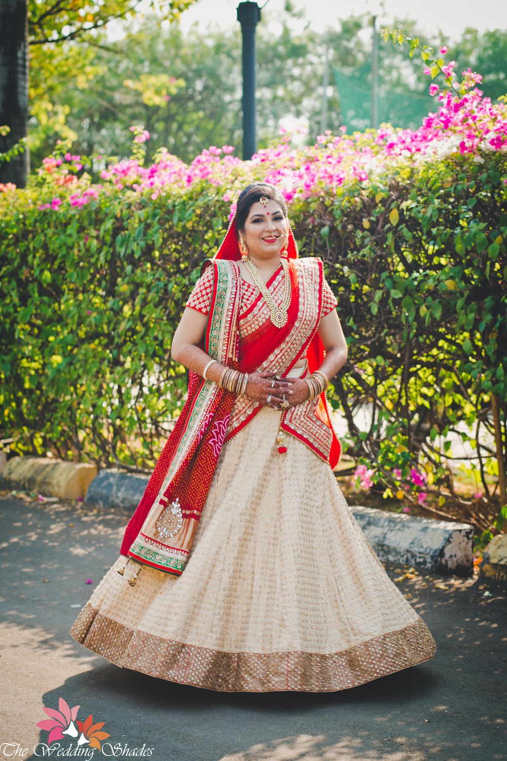 Photo of White Red and Gold Light Bridal Lehenga with Sequins