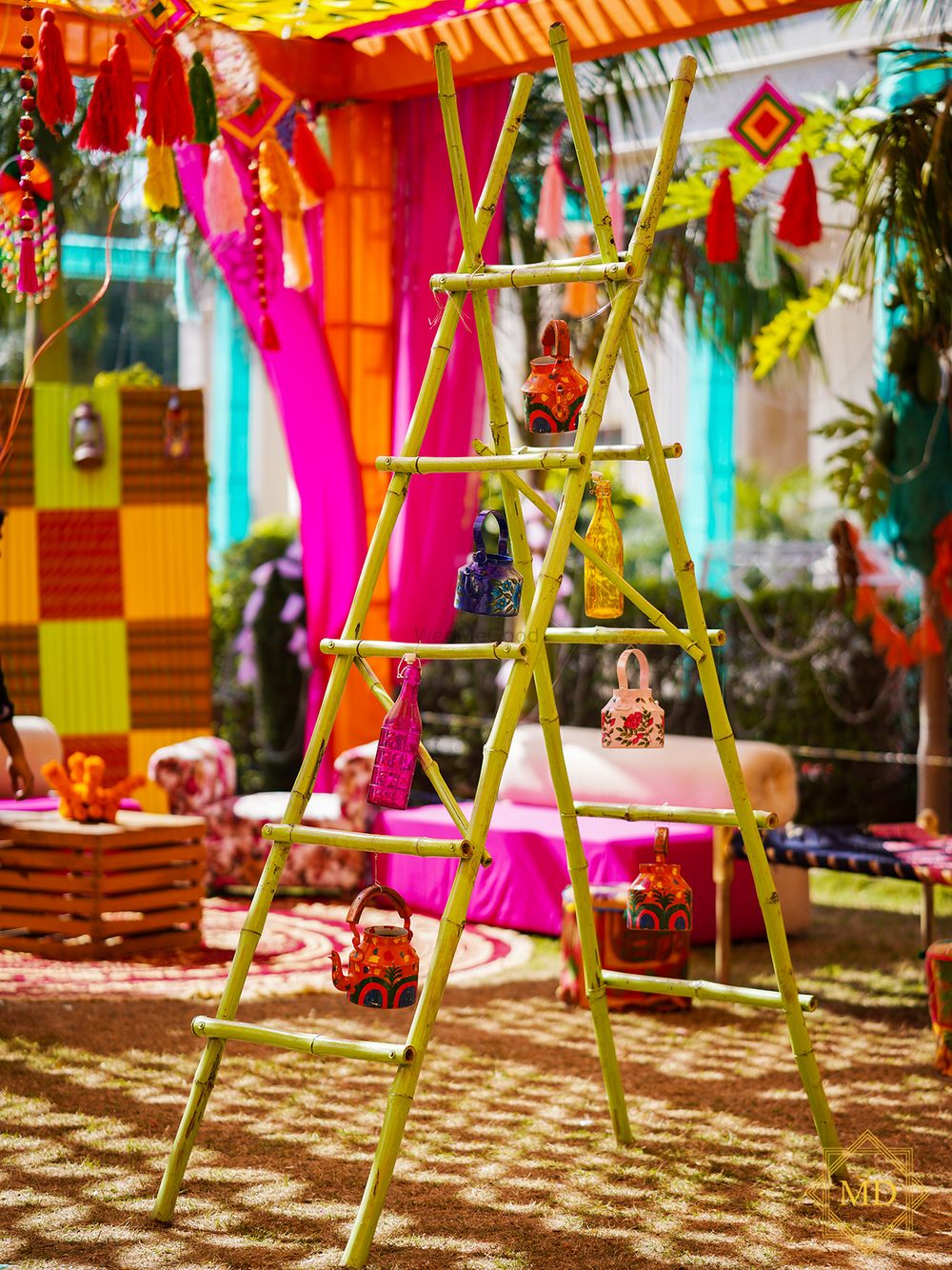Photo of Ladder decorated with kettles, glass bottles and more for mehndi photobooth
