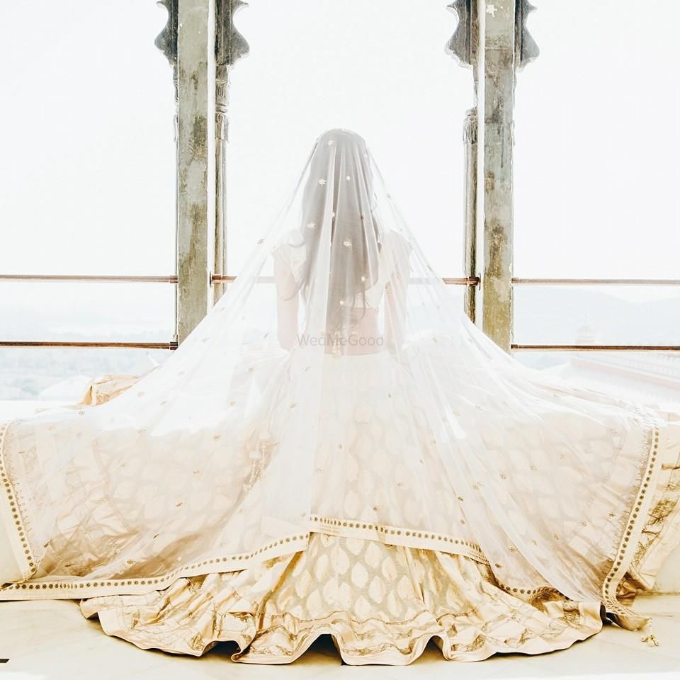 Photo of white bridal lhenga with veil