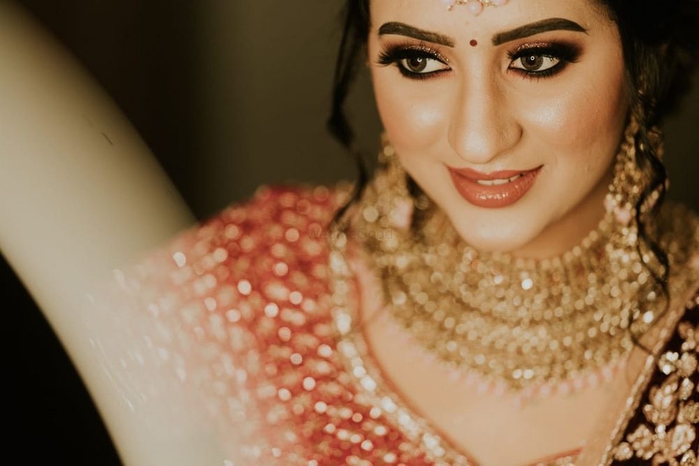 Photo of gold and brown bridal look with bold brows