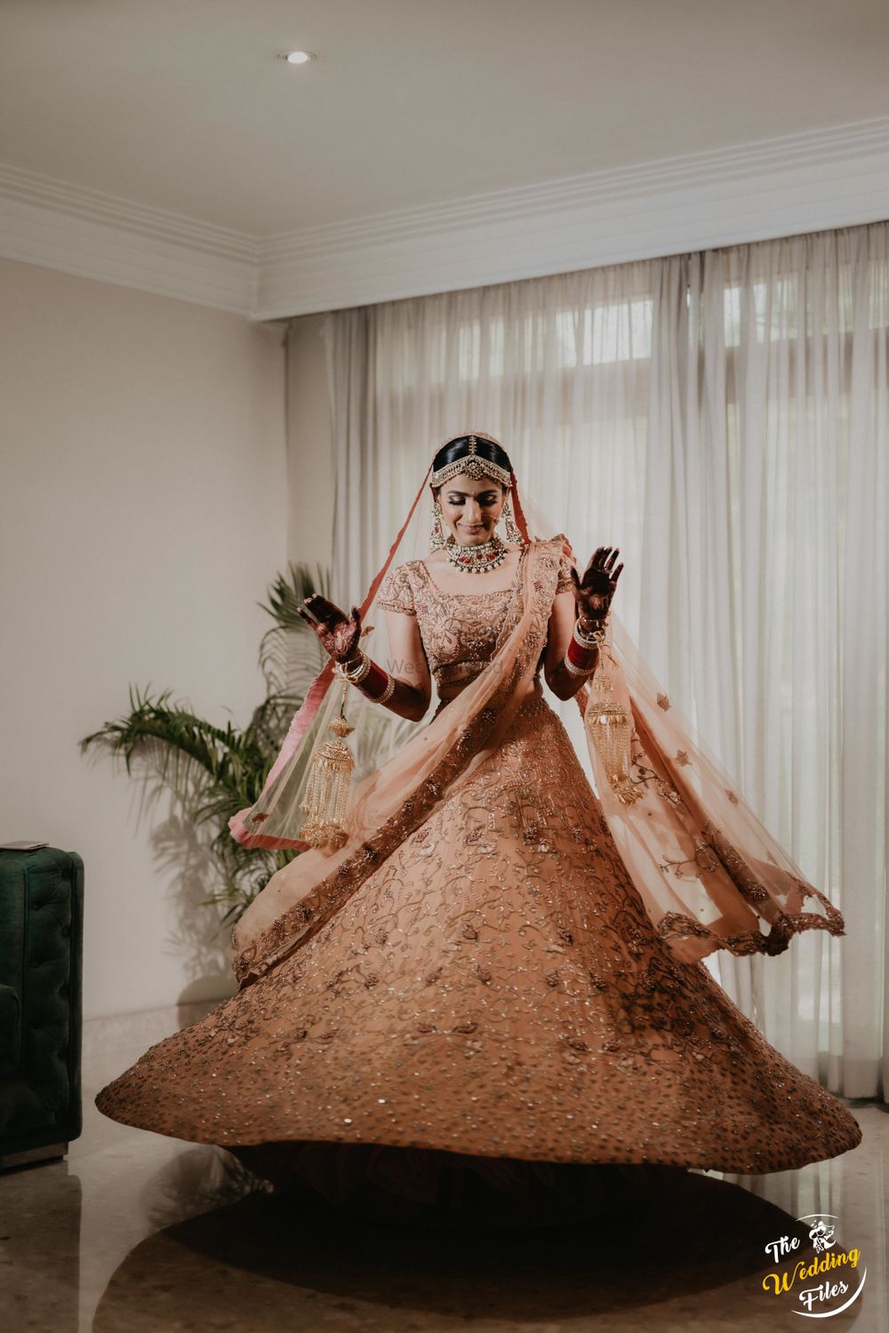 Photo of Bride twirling in a beautiful pastel lehenga.