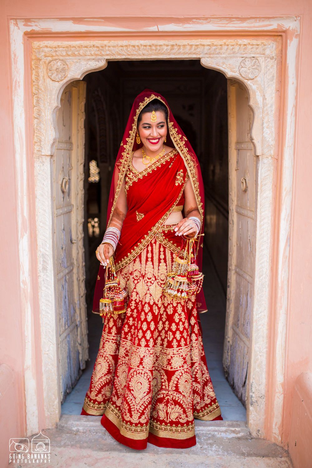 Photo of Bride Entering in Bright Red and Gold Bridal Lehenga