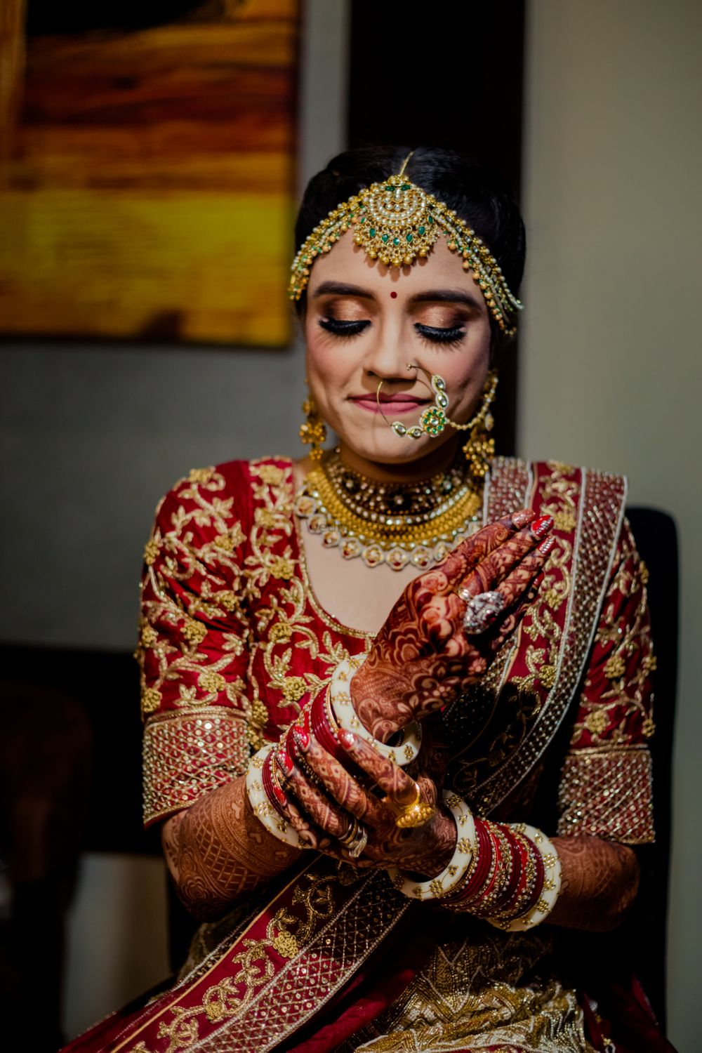 Photo of Getting ready shot of a bride adjusting her bangles.