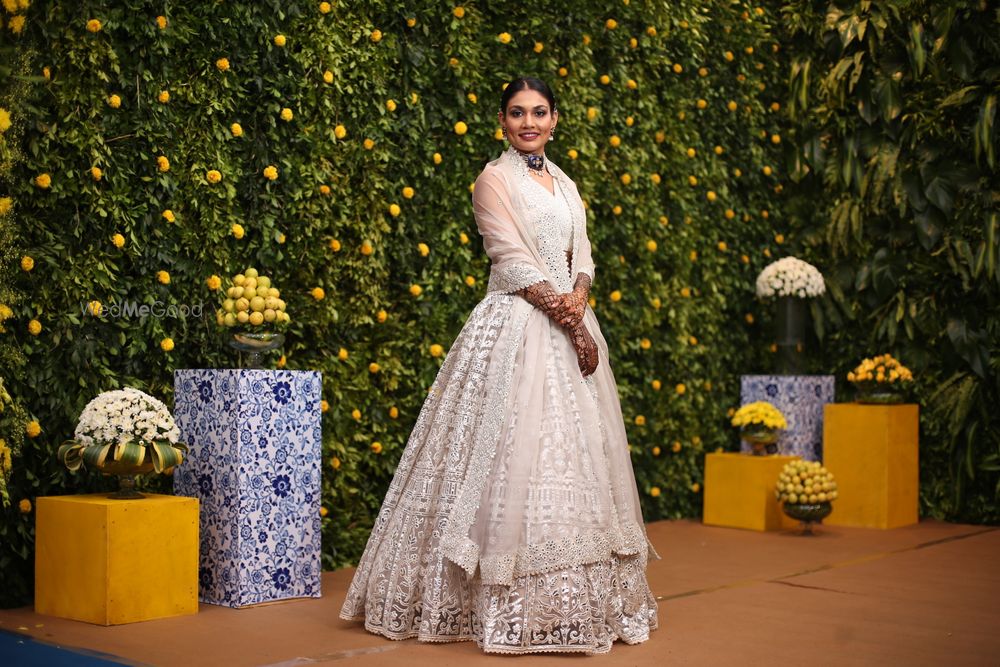 Photo of unique engagement look for bride in an ivory lace lehenga